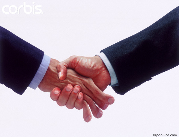 15 Apr 2000 --- An intimidating handshake --- Image by © John Lund/CORBIS